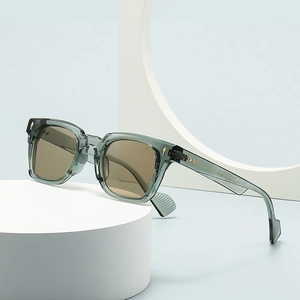 Modern cat-eye sunglasses in translucent green frame with golden arrow accents