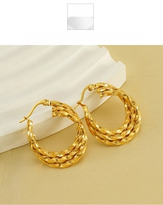 Macro detail of 18K gold plated multi-layer twisted rope hoop earrings with rich texture