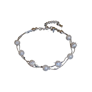 Double-layer necklace with white faux pearls and sparkling rhinestone-studded balls