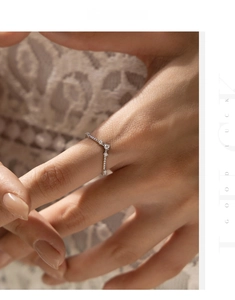 Detailed view of elegant V-shaped S925 sterling silver ring with small moissanite stones