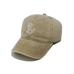 Close-up of dog embroidery on khaki washed cotton baseball cap with curved brim