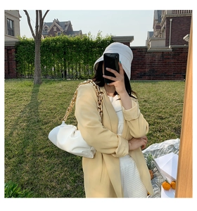 White PU leather cloud bag with chunky gold chain strap worn with a chic yellow blazer