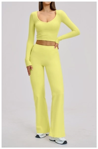 Close-up of lime green sports set with long sleeve crop top and flared yoga pants