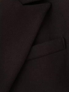 Close-up detail of high-quality wool fabric texture and stitching on lapel and pocket