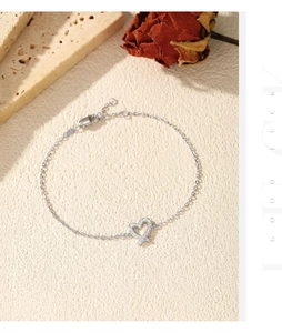 Macro shot of silver heart bracelet with pavé cubic zirconia on minimalist stone background