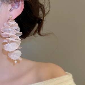 Detailed close-up of long tassel earrings with pink chiffon petals and pearl accents
