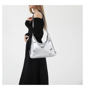 Detail of silver shoulder bag featuring textured PU leather and 3D metallic butterfly accents