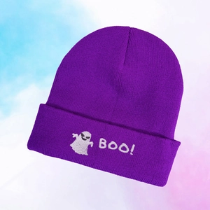 Close-up of a purple knitted beanie featuring white ghost embroidery and BOO text