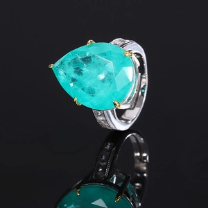 Pear cut Paraiba green tourmaline ring with silver band and side diamond accents