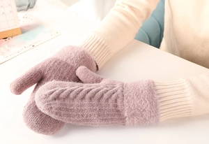 Detail of warm lavender knitted winter gloves with soft faux fur trim for women