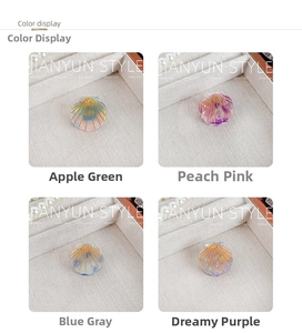 Detailed color display of shell-shaped hair clips in green, pink, blue, and purple tones