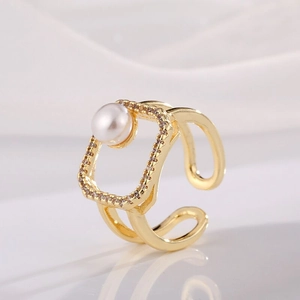 Detail of adjustable gold-plated ring with micro-set zircon square and pearl accent
