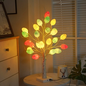 Birch tree LED lamp with colorful crackle Easter eggs on marble table for warm decor