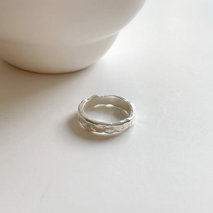 Detailed macro shot of 925 sterling silver ring with irregular lava rock texture