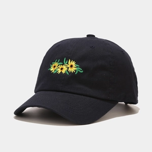 Close-up of sunflower embroidery detail on a black cotton baseball cap for women