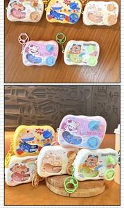 Handheld mechanical water ring toss game keychain featuring cute cartoon capybara and cat