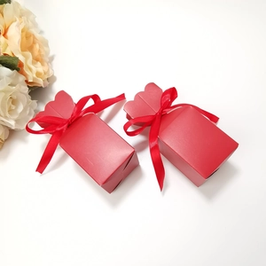 Detail of red striped gift boxes with matte cardstock finish and matching satin ribbons