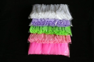 Macro view of colorful plastic spatula set neatly packed in transparent poly bags
