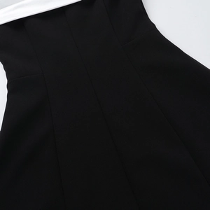 Close-up detail of slimming waistline with black and white contrast stitching and texture