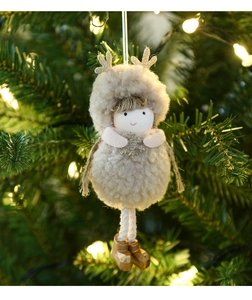 Detail of plush Christmas reindeer angel doll ornament hanging on a warm lit Xmas tree
