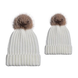 Detail of white rib-knit family hat set with fluffy brown faux fur pom-poms