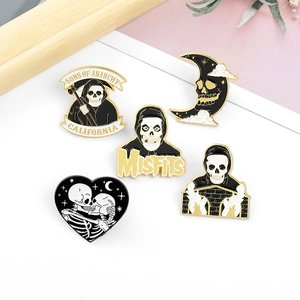 Gothic punk enamel pin set featuring Reaper and Misfits skull motifs in gold and black
