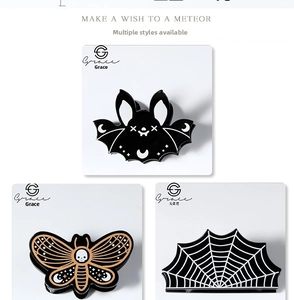 Gothic Halloween hair clips featuring spider web, bat and skull moth designs in black
