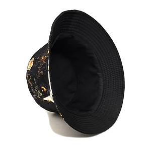 Detail view of black bucket hat featuring artistic cat and floral print on canvas fabric