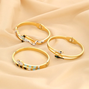 Elegant gold snake-shaped open bracelets with sparkling crystals and enamel on silk
