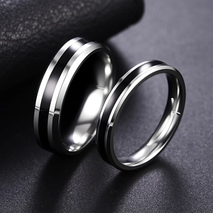 Polished silver and black stainless steel couple rings set on luxury black leather