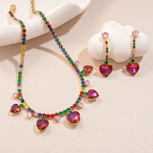 Detailed macro shot of luxury heart tassel necklace and zircon earrings jewelry set