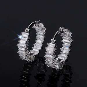 Macro shot of silver hoop earrings with channel-set baguette AAA cubic zirconia stones