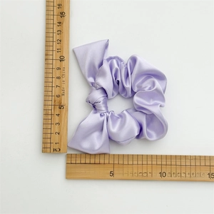 Light purple satin scrunchie shown with rulers measuring size on white background