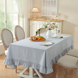 Blue striped rectangular tablecloth with ruffled edges in a cozy dining room setup