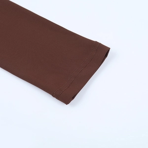 Macro view of double-needle stitching on the cuffs of a brown long-sleeved jumpsuit