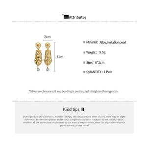 Detail view of geometric hollow gold earrings with grey pearl drops and size specs