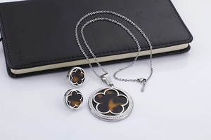 Detailed view of silver jewelry set with brown resin flower pattern and small crystals