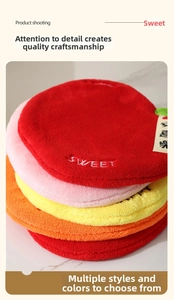 Detail of colorful fruit-themed hanging hand towels with soft coral fleece texture