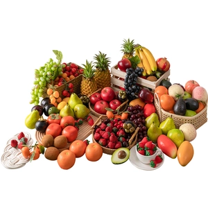 Assorted artificial fruit collection with apples, bananas and grapes in a basket
