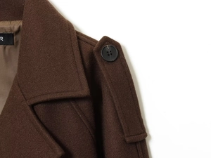 Detail of brown wool coat featuring lapel collar, shoulder epaulets and premium lining