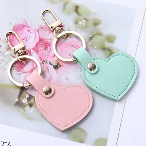 Charming heart-shaped leather keychains in pink and mint green with golden metal rings