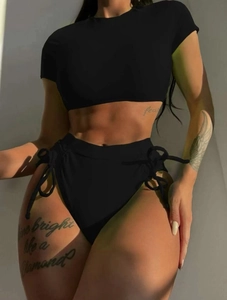 Detail of high waisted black bikini bottom with side drawstring and matte finish fabric