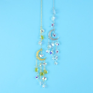 Detailed view of gold and silver suncatchers with crystal stars and moon on blue background
