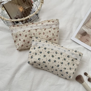 Detailed view of floral storage bags with elegant white lace trim and zipper closures