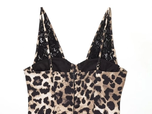 Detail of leopard print dress featuring adjustable straps, black lace trim, and back zipper