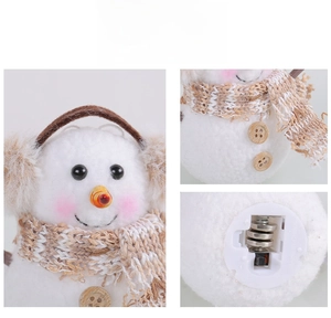 Detail view of glowing snowman plush featuring plaid scarf and battery compartment