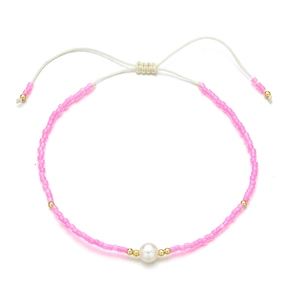 Detail of pink seed bead bracelet with a white freshwater pearl and adjustable cord