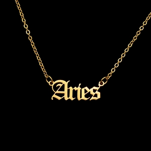 Macro view of Aries gothic pendant necklace in gold-plated stainless steel on black background
