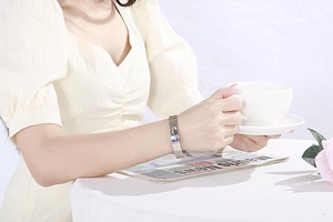 Elegant gold celestial bangle with stars and moon worn during a French afternoon tea