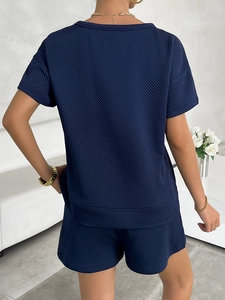 Detailed back view of navy blue knitted lounge set showing geometric diamond texture